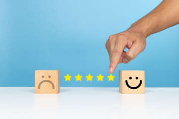 Service rating, satisfaction and positive feedback concept. Customer choose five star slide bar with smile face emoticon indicates satisfaction for the rating