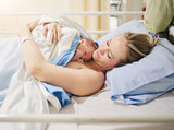 Fototapeta  - Birth, love or skin with mother and baby in hospital for healthcare, maternal security or medical. Bed, family and safety with woman hugging newborn infant in maternity ward of clinic for warmth