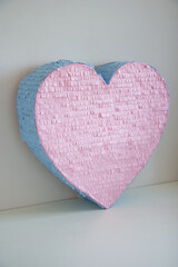 Wall Mural - pink blue heart made of cardboard, piñata heart with candies for a children's party