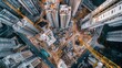 © AGCreative - Aerial view of urban construction site surrounded by skyscrapers with cranes and heavy machinery, showcasing city development.