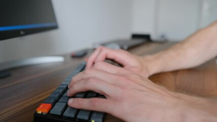 A programmer typing on the keyboard from home
