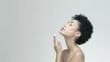 © happysunstock - Radiant Beauty: Elegant Woman Applying Moisturizer for Healthy Skin Care Routine in Studio Light on White Background, Beauty Concept, Generative Ai