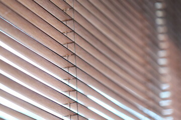 Poster - A close-up shot of wooden blinds on a window, suitable for interior design or home decor concepts.