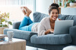 © Sanc/peopleimages.com - Woman , laptop and relax on home portrait, browsing and internet for social networking in living room. Communication, online shopping and website with happy customer in house, smile and tech on sofa