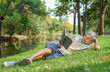 © Verin - healthy senior man lying on grasses in the nature park,reading a book,mature male relaxing in the morning sunshine
