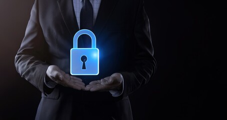 Businessman in suit holding blue glowing padlock icon on black background symbolizing cyber security concept