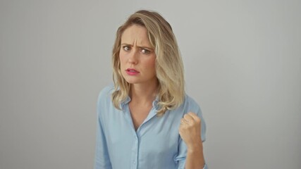 Wall Mural - Furious blonde woman in shirt, fists up, angry rage boiling over. frustration painted on beautiful face, isolated white background