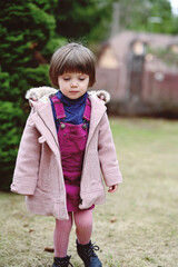 Toddler girl in pink coat