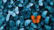 © svastix - Striking image showcasing a unique orange butterfly standing out among a sea of blue butterflies, emphasizing themes of individuality and beauty in nature.