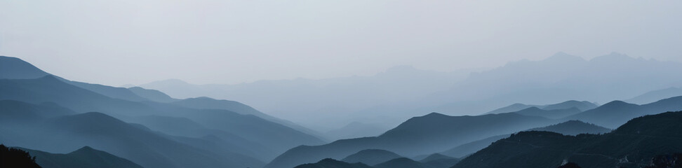 Wall Mural - wide panoramic photo of the mountains against the blue sky