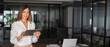 © Stock 4 You - Latin mature adult professional business woman looking at online trade app. European businesswoman CEO holding digital tablet using tab application standing at workplace in office. Banner, copy space