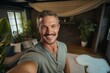 © alisaaa - smiling man taking selfie at home