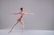 © Maria Moroz - young slender ballerina in pointe shoes and a pink leotard dances on a white background