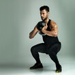 © ThurstanBuyout/peopleimages.com - Squat, athlete or Indian man with kettlebell or power for muscle, health or wellness on grey background. Strong bodybuilder, leg exercise or model with weight for fitness training, workout or balance