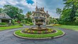 © Abdul - Suburban Victorian home with a beautifully restored fountain in the center of a circular driveway, surrounded by manicured lawns and flower beds
