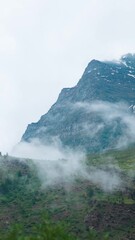 Wall Mural - Vertica shot of monsoon clouds below the mountains as seen from Manali in Himachal Pradesh, India. Clouds under the Himalayan mountains during the monsoon season. Natural cloud background in Himalayas