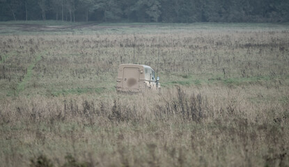 Wall Mural - British army Land Rover Wolf medium utility vehicle moving across countryside