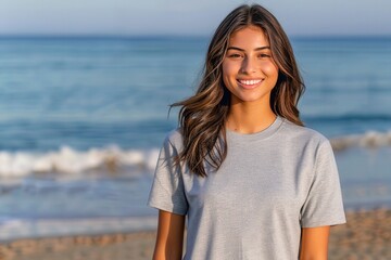 Wall Mural - fashion model mock up tshirt of a woman shoulder length hair standing at the beach wearing a white colored blank Gildan 5000 t-shirt 