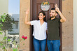 © AntonioDiaz - Young couple going out their house and waving and greeting some of her neighbors