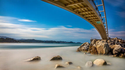 Long exposure and summer view of wave on seaside rock with arch bridge at Namae-ri of Yangyang-gun, South Korea
