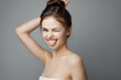 © SHOTPRIME STUDIO - Angry woman with towel on head and hands on head in front of gray background