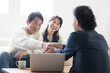 © kapinon - Smiling couple in their 50s receiving explanations from a salesperson Investment, insurance, real estate, etc. Wife happy with handshake and applause upon conclusion of contract.