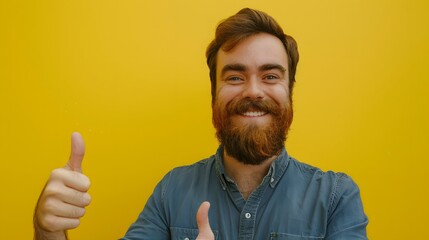 Young handsome man with beard over isolated yellow background with thumbs up because something good has happened.