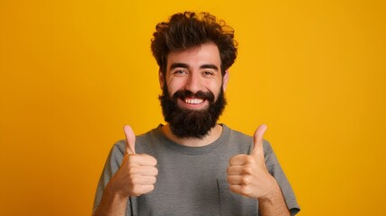 Wall Mural - Young handsome man with beard over isolated yellow background with thumbs up because something good has happened.