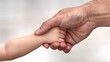 © naphat - High resolution images Close-up of an adult's hand holding a little child's hand, with both hands connected together. The background is blurred with light tones. The focus should be on capturing the