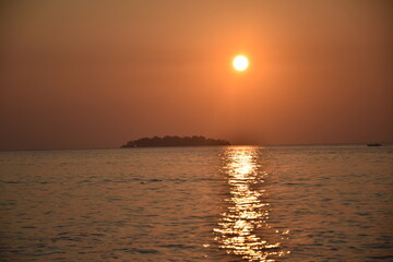 Wall Mural - Beautiful sunset from a distance of small islands around the coast of Tanjung Gelam, Karimunjawa Islands, Central Java, Indonesia
