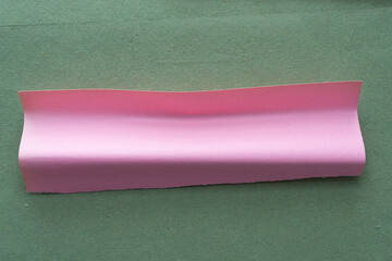 Poster - piece of 3d pink construction paper shape on green