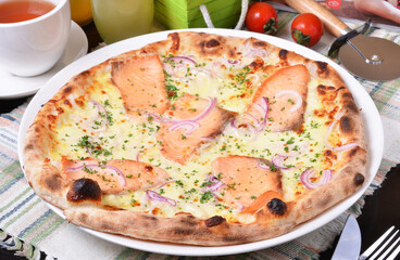 Wall Mural - Delicious fresh salmon pizza on wooden table. 