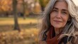 © The Little Hut - Closeup portrait of naturally beautiful senior cute grayhaired woman standing in park in autumn wearing coat looking at camera smiling Pretty mature kind goodlooking female on fresh ai : Generative AI