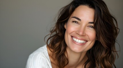 Big bright white smile headshot with a beautiful brunette woman sincere happy cheerful positive expression. 