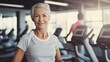 © ittipol - Portrait of  sporty elderly woman in gym.generative ai