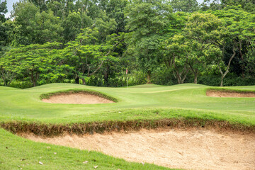 A small flag in golf cause with green view.