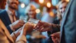 © toomi123 - A close-up of hands exchanging a business card during a networking event