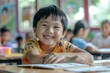 © Ольга Лукьяненко - An asian happy kid is sitting at school lesson