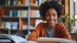 © atipong - Young black woman smiling while reading documents at home sitting in front of desk with papers and books concept of copy space.