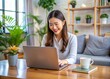 © Man888 - Happy young woman working remotely on virtual video team meeting call, remote work and flexible culture concept, smiling asian female digital nomad freelancing on laptop from home, copy space