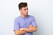 © luismolinero - Young handsome Brazilian man isolated on white background keeping the arms crossed