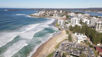 Wall Mural - Aerial drone view of Cronulla beach in the Sutherland Shire, South Sydney, NSW Australia during high surf conditions on a sunny morning on 14 July 2024 heading toward Cronulla rock pools   