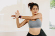 © Suthida - Asian Thai woman wearing sportswear, standing and stretching arms after done workout gym in the morning.