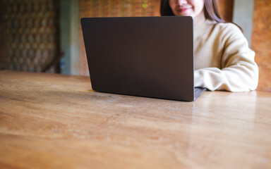 Wall Mural - Closeup image of a young woman working on laptop computer