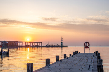 Wall Mural - Sunrise on the shore and harbor of a lake in summer. Colorful sky with a wide view of the Horiont. Nature landscape at Tihany marina, Balaton, Lake Balaton, Siófok, Hungary