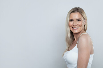 Portrait of attractive mature woman posing on white background