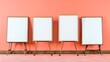 © Galib - Four blank whiteboards on easels in front of a coral wall.