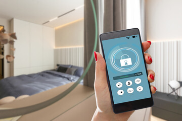 Smart home automation app on smartphone hold by female hand with home interior in background