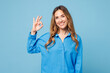 © ViDi Studio - Young smiling happy cheerful satisfied woman she wear shirt casual clothes showing okay ok gesture looking camera isolated on plain pastel light blue cyan background studio portrait Lifestyle concept