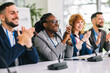 © Mediteraneo - Group of multiracial business people applauding on a business meeting.